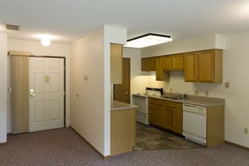 Lake Park apartment for rent - A kitchen area with a sink, stove, and cabinets.