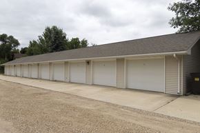 Lake Park apartment for rent - A long building with a grey roof and white garage doors.