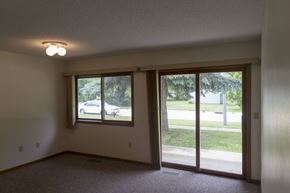 Lake Park apartment for rent - A room with a sliding glass door leading to a backyard.