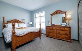 Spencer apartment for rent - A bedroom with a bed, dresser, and mirror.