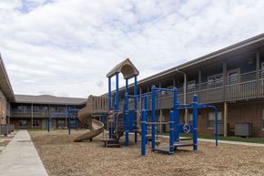 Spencer apartment for rent - A playground with a blue structure and a slide.