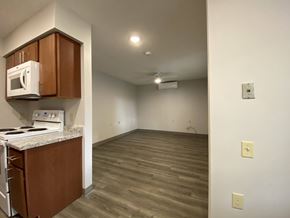 Spencer apartment for rent - A kitchen with a microwave, oven, and stove top.