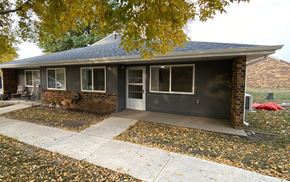 Spencer apartment for rent - A house with a grey roof and a grey garage door.