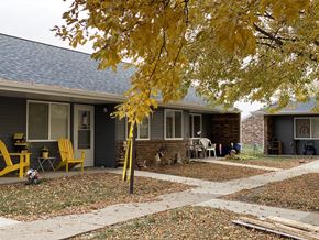 Spencer apartment for rent - A yellow chair is in front of a house.