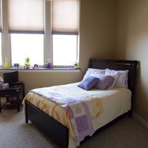 Spencer apartment for rent - A bedroom with a bed, a desk, and a window.