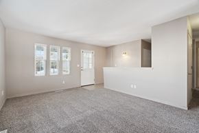 Cedar Rapids apartment for rent - A spacious room with carpeted floor and a large window.
