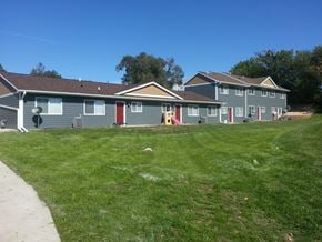 Cedar Rapids apartment for rent - A row of houses with a clear blue sky above them.