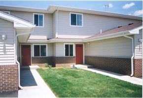 Council Bluffs apartment for rent - A house with a red door and a green lawn.