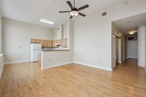 Clinton apartment for rent - A room with wooden floors and a ceiling fan.