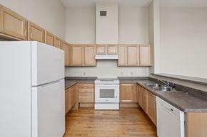 Clinton apartment for rent - A kitchen with wooden cabinets and a white refrigerator.
