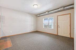 Clinton apartment for rent - A room with a window, a door, and a carpeted floor.