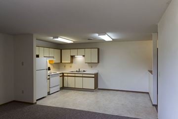 Forest City apartment for rent - A kitchen with white cabinets and a white refrigerator.