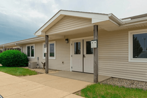 Moville apartment for rent - A house with a grey siding and a white door.