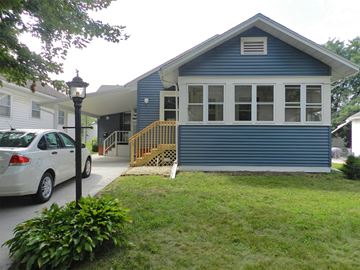 Cedar Rapids apartment for rent - A blue house with a white car parked in front.