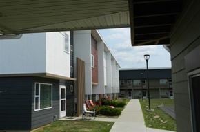 Cedar Rapids apartment for rent - A view of a building with a lawn in front.