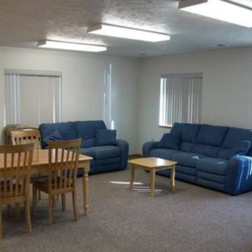 Council Bluffs apartment for rent - A living room with blue couches and wooden furniture.
