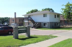 Sioux City apartment for rent - A white house with a sign in front of it.