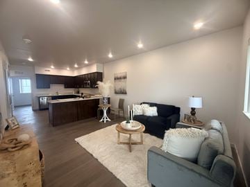 Hawarden apartment for rent - A living room with a grey couch and a wooden coffee table.