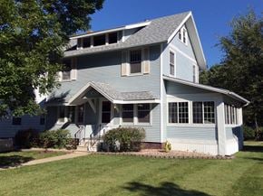 Cedar Rapids apartment for rent - A two-story house with a front porch and a small front yard.