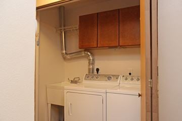 Des Moines triplex for rent - A white sink and dishwasher in a small kitchen.
