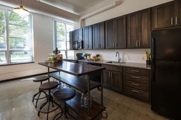 West Des Moines apartment for rent - A kitchen with a table and chairs in front of a window.