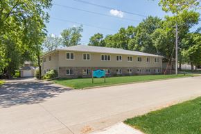Spirit Lake apartment for rent - A building with a green sign in front of it.