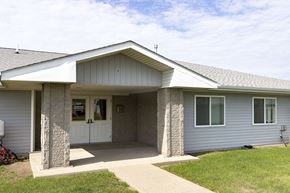 Hawarden apartment for rent - A house with a grey siding and a white roof.