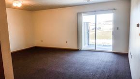 Hawarden apartment for rent - A room with a carpeted floor and a sliding glass door.