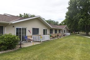 Sibley apartment for rent - A house with a white fence and a flag on the front porch.