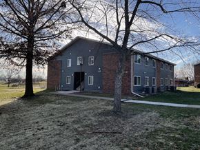 Fairfield townhouse for rent - A grey building with a tree in front of it.