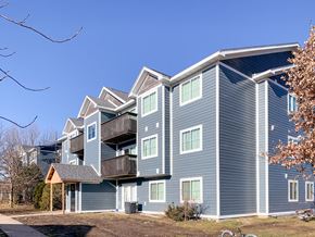 North Liberty apartment for rent - A large blue building with a balcony on the second floor.