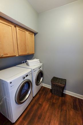 West Des Moines apartment for rent - A laundry room with a washer and dryer stacked on top of each other.