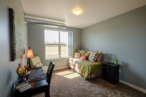 West Des Moines apartment for rent - A bedroom with a bed, a chair, and a desk.