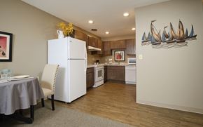 Spencer apartment for rent - a kitchen with a white refrigerator freezer next to a white stove top oven