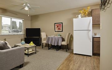 Spencer apartment for rent - a living room with a dining room table and a refrigerator