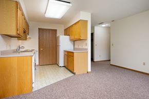 Lake Park apartment for rent - A kitchen with wooden cabinets and a white refrigerator.