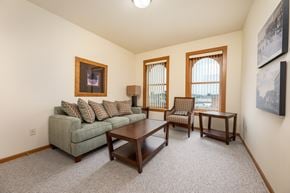 Spirit Lake apartment for rent - A living room with a couch, chair, and coffee table.