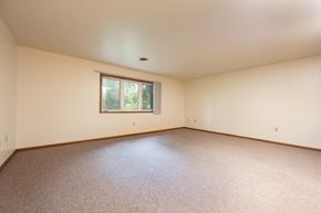 Spirit Lake apartment for rent - Empty room with a window and carpeted floor.