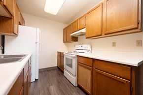 Spirit Lake apartment for rent - A kitchen with white appliances and wooden cabinets.