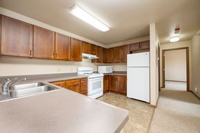 Milford apartment for rent - A kitchen with white appliances and wooden cabinets.
