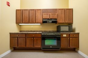 Spencer apartment for rent - A kitchen with wooden cabinets and a black oven.