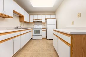 Hartley apartment for rent - A kitchen with white cabinets and a white oven.