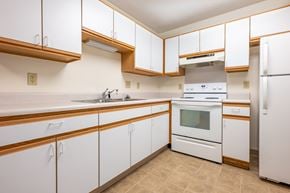 Hartley apartment for rent - A kitchen with white cabinets and a white oven.