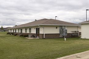 Spirit Lake apartment for rent - A house with a brown roof and a white garage door.