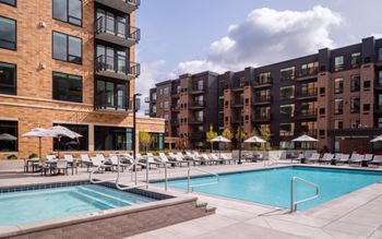 A swimming pool in front of an apartment building