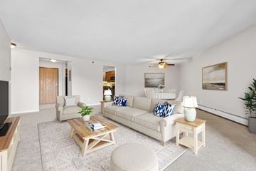 Little Canada apartment for rent - A living room with a white couch and a coffee table.