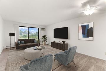 Burnsville apartment for rent - A living room with a grey chair and a brown sofa.