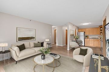 St. Louis Park apartment for rent - A living room with a white couch, a coffee table, and a painting on the wall.
