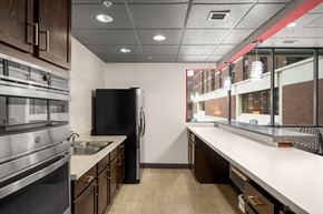 St. Paul apartment for rent - A modern kitchen with a black refrigerator and stainless steel appliances.