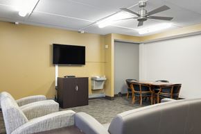 Robbinsdale apartment for rent - A conference room with a television, chairs, and a table.